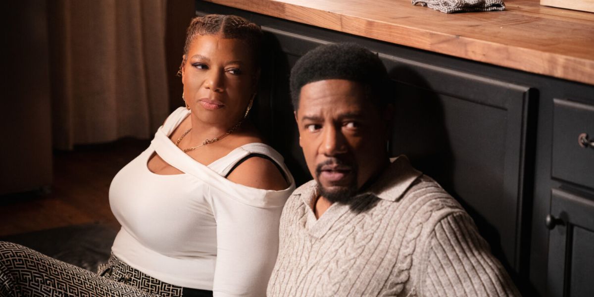 Robyn and Dante hiding behind a kitchen counter on "The Equalizer."